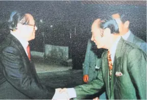  ??  ?? Kamphol, right, shakes hands with former Chinese president Jiang Zemin, during a visit to China.