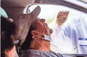  ??  ?? Theodore Lawrence gets tested for coronaviru­s May 9 by a Dignity Health medical worker at a drive-up testing site at State Farm Stadium from Dignity Health and the Arizona Cardinals in Glendale.