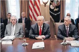  ?? [AP PHOTO] ?? Secretary of State Rex Tillerson, left, and Secretary of Defense Jim Mattis, right, listen as President Donald Trump speaks Wednesday during a cabinet meeting at the White House.