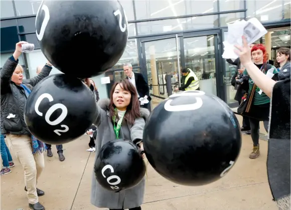  ?? (Wolfgang Rattay/Reuters) ?? ACTIVISTS PROTEST last Friday against the trading of carbon-dioxide emissions in front of the World Congress Center Bonn, the site of the COP23 UN Climate Change Conference, in Bonn, Germany.