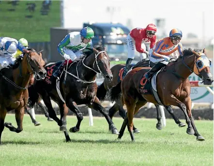  ??  ?? Melody Belle, with Troy Harris in the saddle, on her way to victory at Te Rapa on Saturday