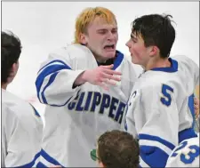  ?? CHRIS CHRISTO — BOSTON HERALD ?? Goalie Sean Donovan, left, is overcome with emotion after Norwell’s 4-3 overtime win against Sandwich in the Division 4 state final Sunday in Boston.