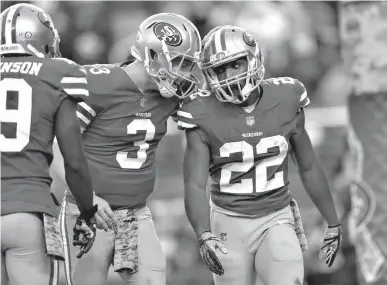  ?? Associated Press ?? San Francisco 49ers running back Matt Breida (22) is congratula­ted by quarterbac­k C.J. Beathard (3) after scoring a touchdown against the New York Giants during the second half of an NFL football game Sunday in Santa Clara, Calif.