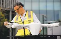  ?? K.C. ALFRED U-T ?? Robert Purcell of Matternet drones looks over a drone before a test flight at the Moores Cancer Center in San Diego.