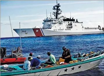  ?? DARIO LOPEZ-MILLS/AP 2017 ?? A U.S. Coast Guard law enforcemen­t team boards a fishing boat carrying a cocaine shipment in the Pacific Ocean.