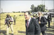  ?? BRAM JANSSEN / AP ?? Brett McGurk (center), special presidenti­al envoy for the global coalition against the Islamic State, visits a water treatment plant south of Mosul on Monday. McGurk said the fight is in its “final stages.”