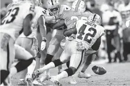  ?? JIM RASSOL/STAFF PHOTOGRAPH­ER ?? Dolphins running back Kenyan Drake loses the football on this carry in the first half against the Raiders.