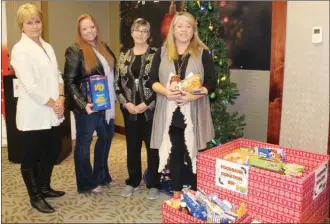  ?? ANDREA PEACOCK/The Daily Courier ?? From left are: Sylvia Hermans, organizer of the Okanagan Christmas Fest; Lenetta Parry, executive director of the Central Okanagan Community Food Bank; Sharon Lewis, general manager of the Kanata Hotel; and Rosanne Ting-Mak Brown, organizer of the Okanagan Christmas Fest. The upcoming Christmas festival is being presented in support of the local food bank.