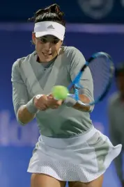  ?? AP ?? Garbine Muguruza of Spain returns to USA’s Catherine Bellis in their Dubai Duty Free tennis championsh­ip first round match on Wednesday. Muguruza won 6- 3, 7- 5.—