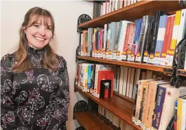  ?? Ned Gerard/Hearst Connecticu­t Media ?? Head librarian Christine Catallo with some of the Spanish and Hindi language books on the shelves at the Pequot Library in Fairfield.