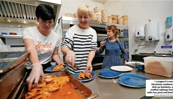  ?? Andrew Matthews/PA wire ?? Langport’s new Ukrainian residents dish up Golubsty, a stuffed cabbage leaf with rice, pork and beef