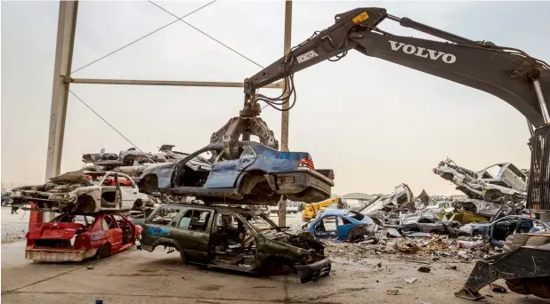  ??  ?? MINCING MACHINE... A crane lifts a car frame at Bee’ah’s car and metal shredding facility, which features one of the most powerful shredding machines — The Red Giant — that can shred 60 car bodies per hour.