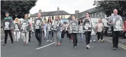  ??  ?? Photos of republican hunger strikers are carried through Castlewell­an