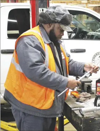  ?? Brodie Johnson • Times-Herald ?? The Forrest City Public Works Department is performing maintenanc­e on its vehicles and machinery in preparatio­n for severe winter weather. FCPWD employee Tony Morgan fits, tightens and oils a chainsaw blade this morning to prepare for the possibilit­y of downed tree limbs following possible freezing rain.