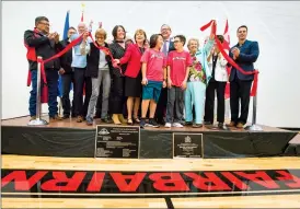  ?? Herald photo by Ian Martens ?? Politician­s, school board officials, dignitarie­s and students celebrate cutting the ribbon Friday morning to officially open Senator Joyce Fairbairn Middle School. @IMartensHe­rald