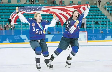  ?? Jung Yeon-Je AFP/Getty Images ?? GOLD MEDALS around their necks, Kendall Coyne, left, and Hilary Knight show who’s No. 1 after the 3-2 shootout victory over Canada.