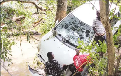  ?? — (Picture by Innocent Makawa) ?? This vehicle was swept by floods for about 500 metres from its owner’s house, and was only stopped from plunging into a river by trees on the bank, after heavy rains pounded Carrick Estate in Borrowdale, Harare, yesterday.