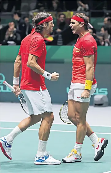  ??  ?? Pair of aces: Feliciano Lopez and Rafael Nadal celebrate during their decisive doubles victory over Britain last night