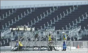  ?? (AP/Eugene Hoshiko) ?? Workers prepare the venue at Kasai Canoe Slalom Centre for the Tokyo 2020 Olympics in Tokyo.