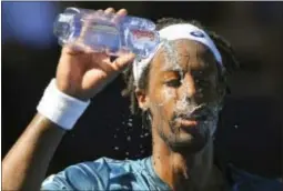  ?? ANDY BROWNBILL — THE ASSOCIATED PRESS ?? Gael Monfils showers himself with water during his second-round match with Novak Djokovic at the Australian Open in Melbourne, Australia, Thursday.