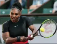  ?? THIBAULT CAMUS — THE ASSOCIATED PRESS ?? Serena Williams returns a shot against Ashleigh Barty during their second-round match at the French Open last May in Paris, France. Williams says her relationsh­ip with the French Open is fine despite the Grand Slam tournament’s plan to ban her skin-tight black catsuit.