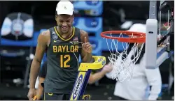  ?? DARRON CUMMINGS — THE ASSOCIATED PRESS ?? Baylor’s Jared Butler cuts down the net on Monday night in Indianapol­is after the Bears had beaten No. 1 Gonzaga, 86-70 for the title.