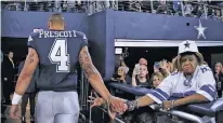  ?? ASSOCIATED PRESS FILE PHOTO ?? Dallas Cowboys quarterbac­k Dak Prescott shakes hands with fans Nov. 23 as he walks into the team’s clubhouse after a 28-6 loss to the Los Angeles Chargers in Arlington, Texas. Prescott and the Cowboys have already lost all realistic hope of defending their NFC East title.