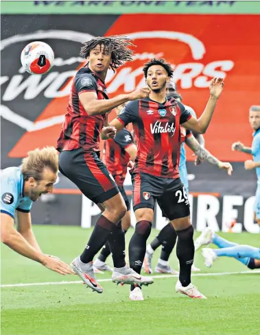  ??  ?? No push over: Spurs striker Harry Kane goes flying under a challenge from Bournemout­h’s Joshua King but the Var decided it was not a penalty