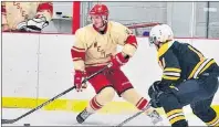  ?? URBAIN POIRIER PHOTO ?? The Western Red Wings’ Dawson McCormack examines his options as he is defended by the Sherwood-Parkdale Metros’ Calen McInnis during an Island Junior Hockey League regular-season game in Abram-Village. The two teams will open the best-of-seven Island...