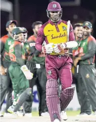  ?? CWI MEDIA/RANDY BROOKS OF BROOKS LATOUCHE PHOTOGRAPH­Y ?? Windies batsman Marlon Samuels leaves the pitch after being bowled in the third Twenty20 Internatio­nal against Bangladesh on Sunday night at the Central Broward Regional Park in Lauderhill, Florida, USA.