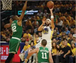  ?? PHOTOS BY NHAT V. MEYER — BAY AREA NEWS GROUP ?? Golden State Warriors' Klay Thompson (11) takes a shot against Boston Celtics' Al Horford (42) in the second quarter of Game 2of the NBA Finals at the Chase Center in San Francisco, Calif., on Sunday, June 5, 2022.