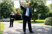  ?? ASSOCIATED PRESS ?? PRESIDENT DONALD TRUMP (center), accompanie­d by Secretary of State Mike Pompeo (left), speaks to members of the media on the South Lawn outside the Oval Office in Washington Friday.