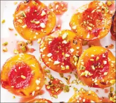  ?? The Associated Press ?? The recipe for honey-glazed roasted peaches appears in the cookbook How to Roast Everything.