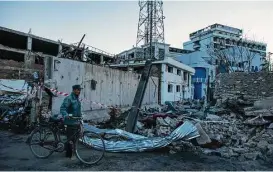  ?? New York Times file ?? An Afghan police officer surveyed the damage from a truck bomb near several embassies in Kabul, Afghanista­n, in May. A huge public works project over the next two years will reshape the center of this city to bring nearly all Western embassies, major...