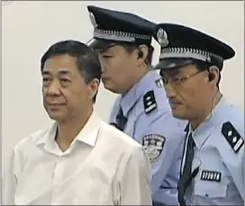  ?? — GETTY IMAGES ?? Ousted Chinese politician Bo Xilai, left, heads to court Thursday for his bribery, embezzleme­nt and abuse of power trial.