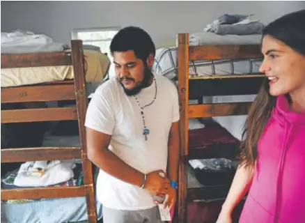  ?? Photos by Helen H. Richardson, The Denver Post ?? Sarah Jackson shows Juan Cruz his room, clothing and toiletries at Casa de Paz in Aurora. The halfway house, founded by Jackson, takes in immigrants and asylum seekers leaving the nearby ICE detention center.
