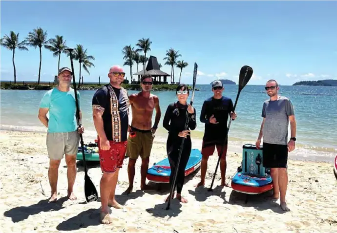  ?? ?? Paddleboar­ders covered 35 kilometers of coastline in 2 days to raise funds for turtle conservati­on and promote sustainabl­e watersport­s. Image courtesy of Sabah Tourism Board.