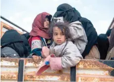  ?? — AFP ?? Civilians who fled from the embattled Baghouz area in the eastern Syrian province of Deir Ezzor sit in a truck during an operation by the Syrian Democratic Forces (SDF) to expel hundreds of IS fighters from the region.