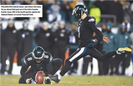  ??  ?? PHILADELPH­IA EAGLES kicker Jake Elliott (#4) kicks the go-ahead field goal out of the hold of punter Donnie Jones (#8) in the fourth quarter against the Oakland Raiders at Lincoln Financial Field.