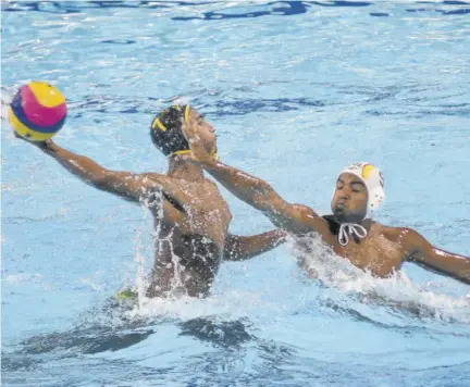  ?? (Photos: Garfield Robinson) ?? Jamaica’s Marlon Mcintyre (left) drills the ball against Colombia in a 2018 tournament at the National Stadium Swimming Pool..