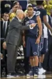  ?? TONY DING — THE ASSOCIATED PRESS ?? Penn State head coach Patrick Chambers, left, gives instructio­ns to guard Shep Garner during a timeout in the second half against Michigan in Ann Arbor, Mich., Saturday. Michigan won, 79-56.