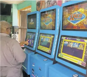  ?? ?? A patron uses one of the video lottery terminals introduced by Mahoe Gaming.