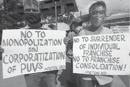  ?? Photo by JJ Landingin ?? CORPORATE TAKE OVER. Piston members in Baguio City march to air their sentiments against the jeepney modernizat­ion saying it will affect their livelihood and the riding public due to the cost of modernized jeeps.