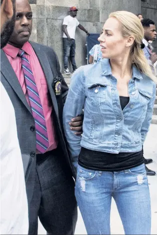  ??  ?? TICK-TOCKED OFF: Unhappy Yulia Sedunova is led from court Friday. She’s accused of stealing, among other pieces, a $69K Audemars Piguet watch like the one at top.