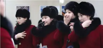  ??  ?? A North Korean cheering squad look at themselves in a mirror in Gapyeong, South Korea