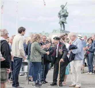  ?? GETTY IMAGES ?? A veteran is congratula­ted at a 2017 service at Sword Beach to commemorat­e the 73rd anniversar­y of the D-Day landings. Lord Lovat’s arrival to relieve troops at Pegasus Bridge is legendary, but his flair for the dramatic has overshadow­ed the actions of a group of commandos who arrived at the bridge before he did.