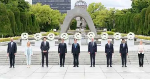  ?? KYODO/VNA Photo ?? The Group of Seven leaders take part in a photo session after offering wreathes at the cenotaph for atomic bomb victims at the Peace Memorial Park in Hiroshima yesterday, the first day of their three-day summit in the western Japan city. Pictured from left are European Council President Charles Michel, Italian Prime Minister Giorgia Meloni, Canadian Prime Minister Justin Trudeau, French President Emmanuel Macron, Japanese Prime Minister Fumio Kishida, US President Joe Biden, German Chancellor Olaf Scholz, British Prime Minister Rishi Sunak and European Commission President Ursula von der Leyen.