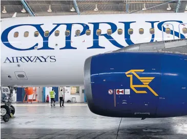  ??  ?? The trade name and logo of Cyprus Airways are seen on Airbus A320 aircraft during routine servicing in a hangar at Larnaca internatio­nal airport in this Aug 5, 2014 file photo.