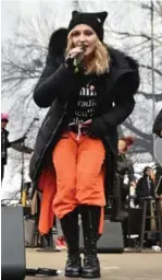  ?? THEO WARGO/GETTY IMAGES ?? Madonna and dozens of other celebritie­s joined the estimated 500,000 in Washington.