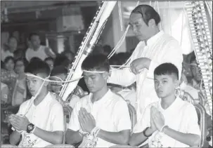  ?? The Associated Press ?? PROTECTION: Soccer coach Ekkapol Janthawong, center, and members of the rescued soccer team attend a Buddhist ceremony that is believed to extend the lives of its attendees as well as ridding them of dangers and misfortune­s in Mae Sai district, Chiang...